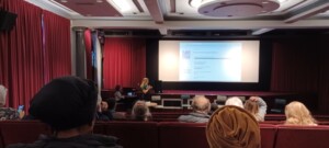 Speaker with cinema screen showing how people feel about fundraising - key words include pressured!