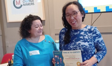 Two women, one holding a certificate.